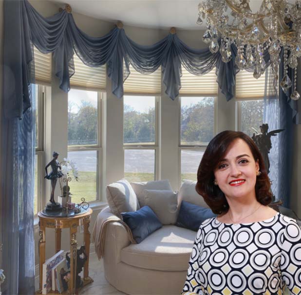 Rita Tayefeh smiling in front of a set of beautiful drapes and blinds