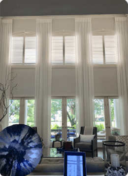 A tall set of curtains in a beautiful living area