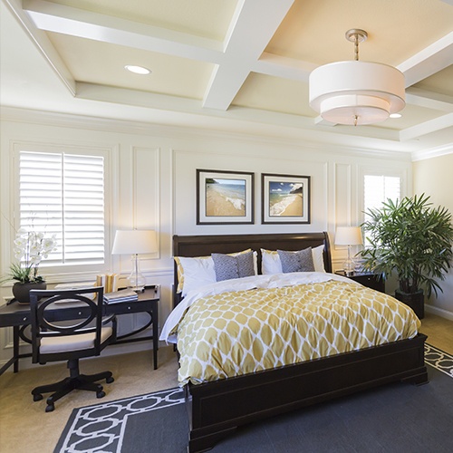 Beautifully decorated bedroom with plantation shutters