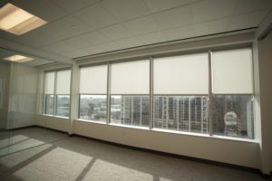 elegant roller shades in windows of Dallas office building