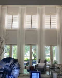 Beautiful, well-designed living room with custom window treatments