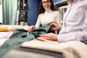 Smiling woman shopping for new window treatments in Dallas