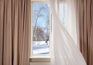 Layered window treatments in Dallas looking out on winter scene