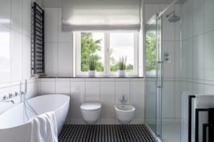 Bathroom with tasteful Roman shades on the window