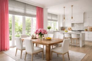 Roman shades layered with pink drapes in pretty kitchen