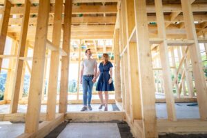 Couple walking through their partially constructed home